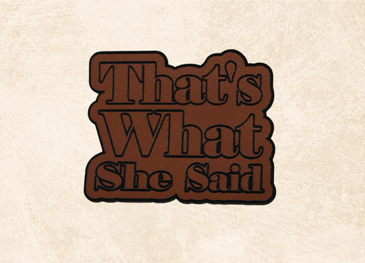 Decorative sign with 'That's What She Said' text on a beige background