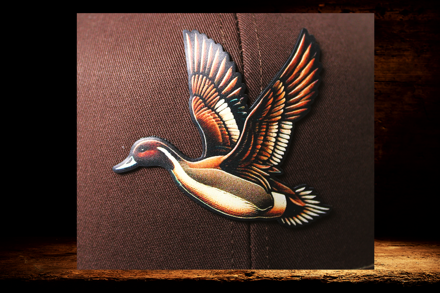 Brown and tan hat with brown flying duck